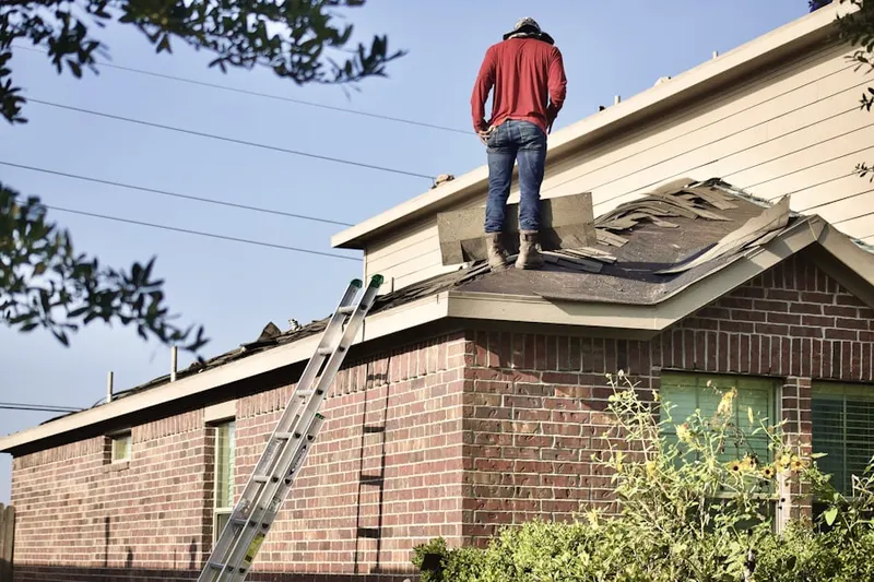Professional roofer working on a residential roof in Plantation Estates